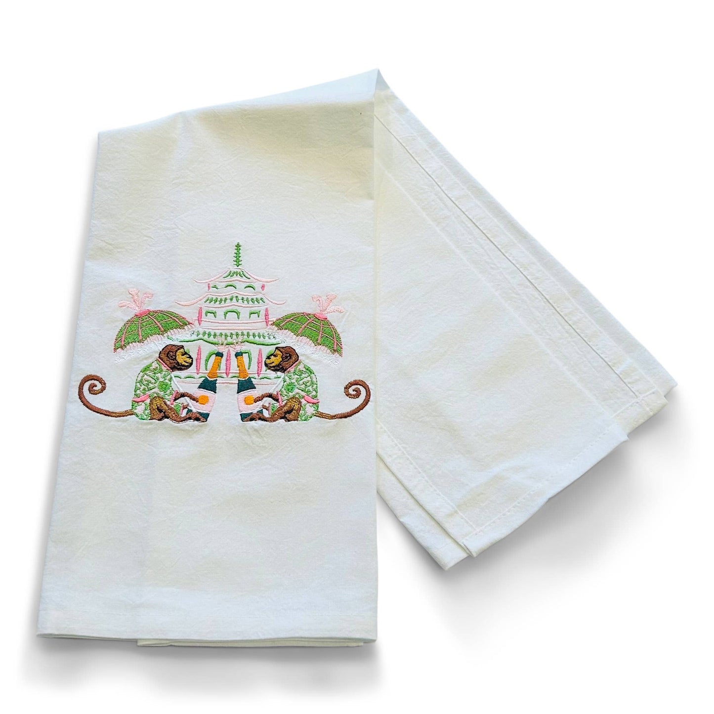 Set of two embroidered towels with a decorative design on a white background