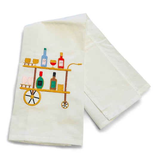 White towel with a bar-themed design featuring bottles and glasses on a cart.