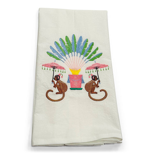 Embroidered towel with monkeys and a fan design on a white background