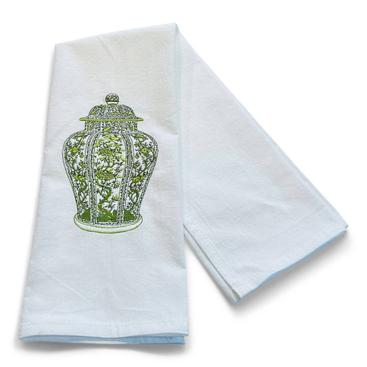 White towel with green decorative design on a white background
