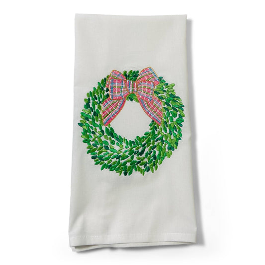White towel with a green wreath and plaid bow design on a white background
