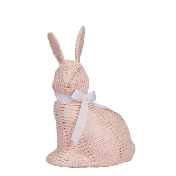 Knitted pink bunny with a white bow on a white background