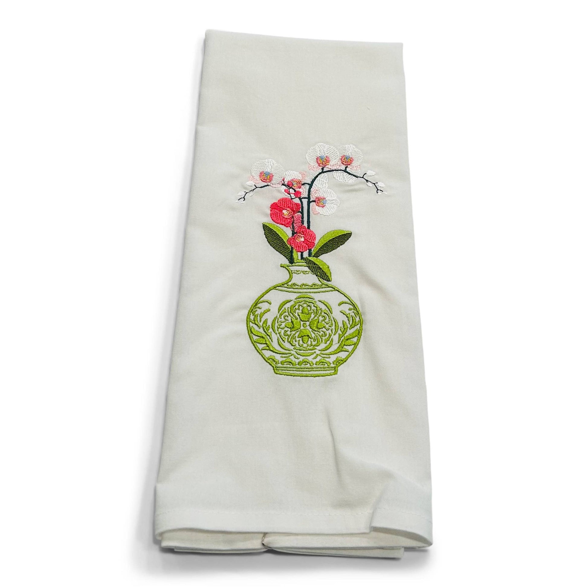 White towel with embroidered design of a green vase with flowers on a white background