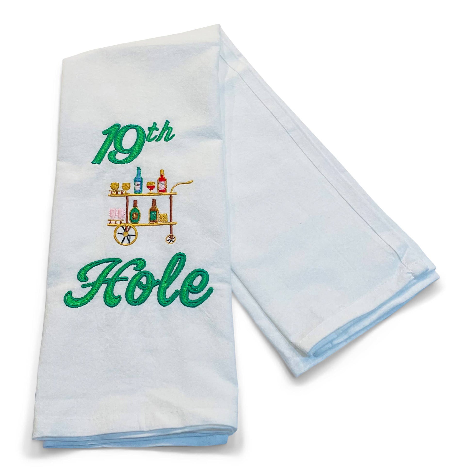 Folded white towel with '19th Hole' embroidery design on a white background