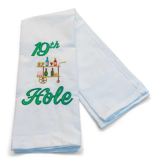 Folded white towel with '19th Hole' embroidery design on a white background